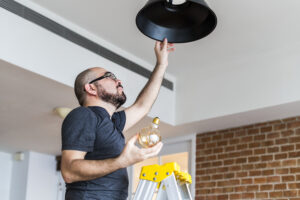 Man changing a light bulb