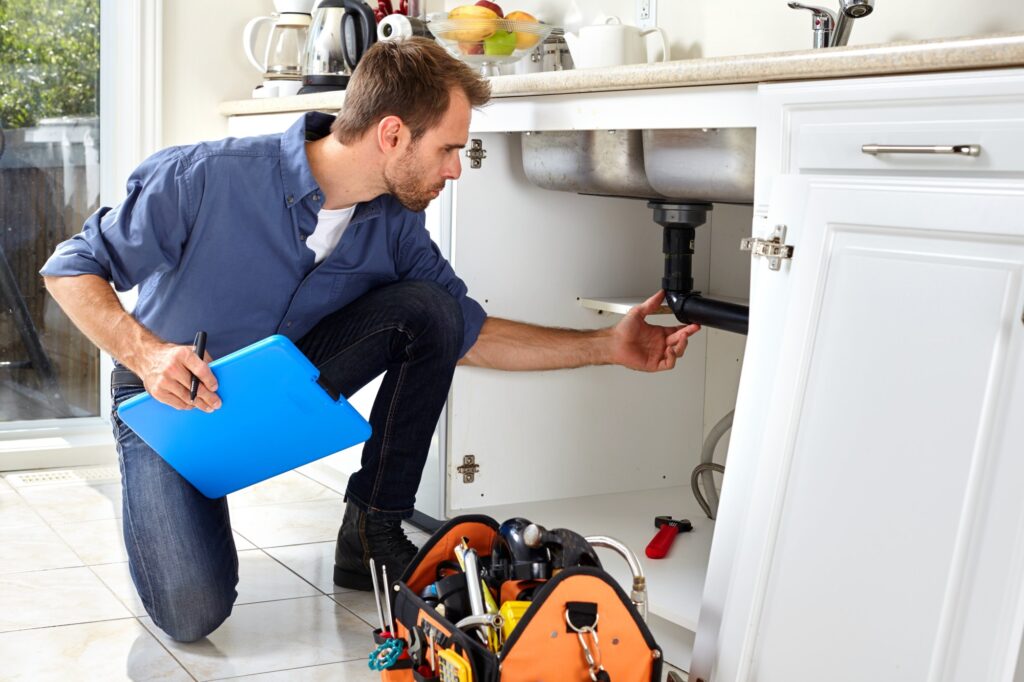 Kitchen sink repair Dubai: plumber at work